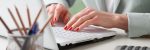 Close-up of businesswoman working on accountancy  with laptop. Small business.
